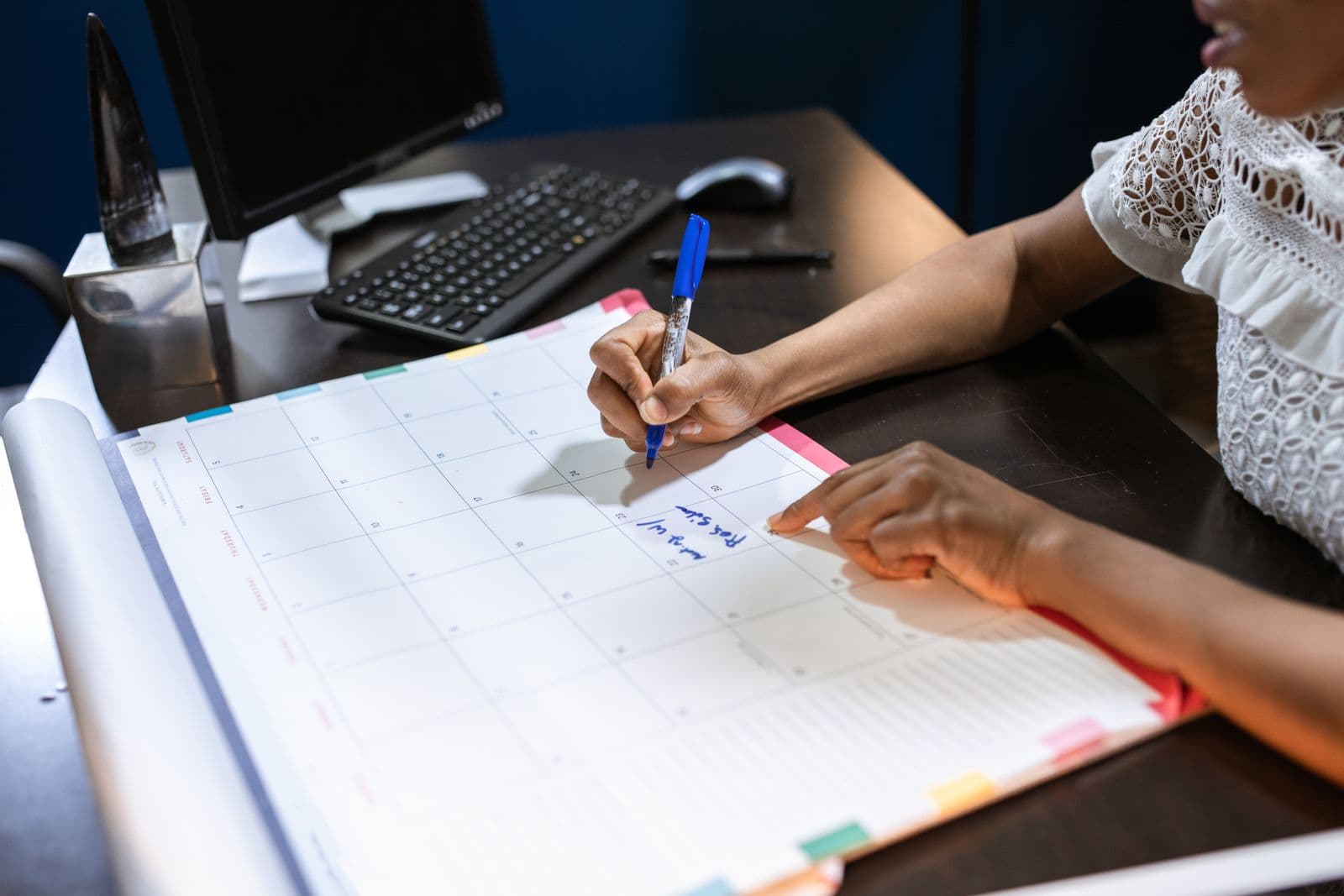 Appointments being written into a desk calendar