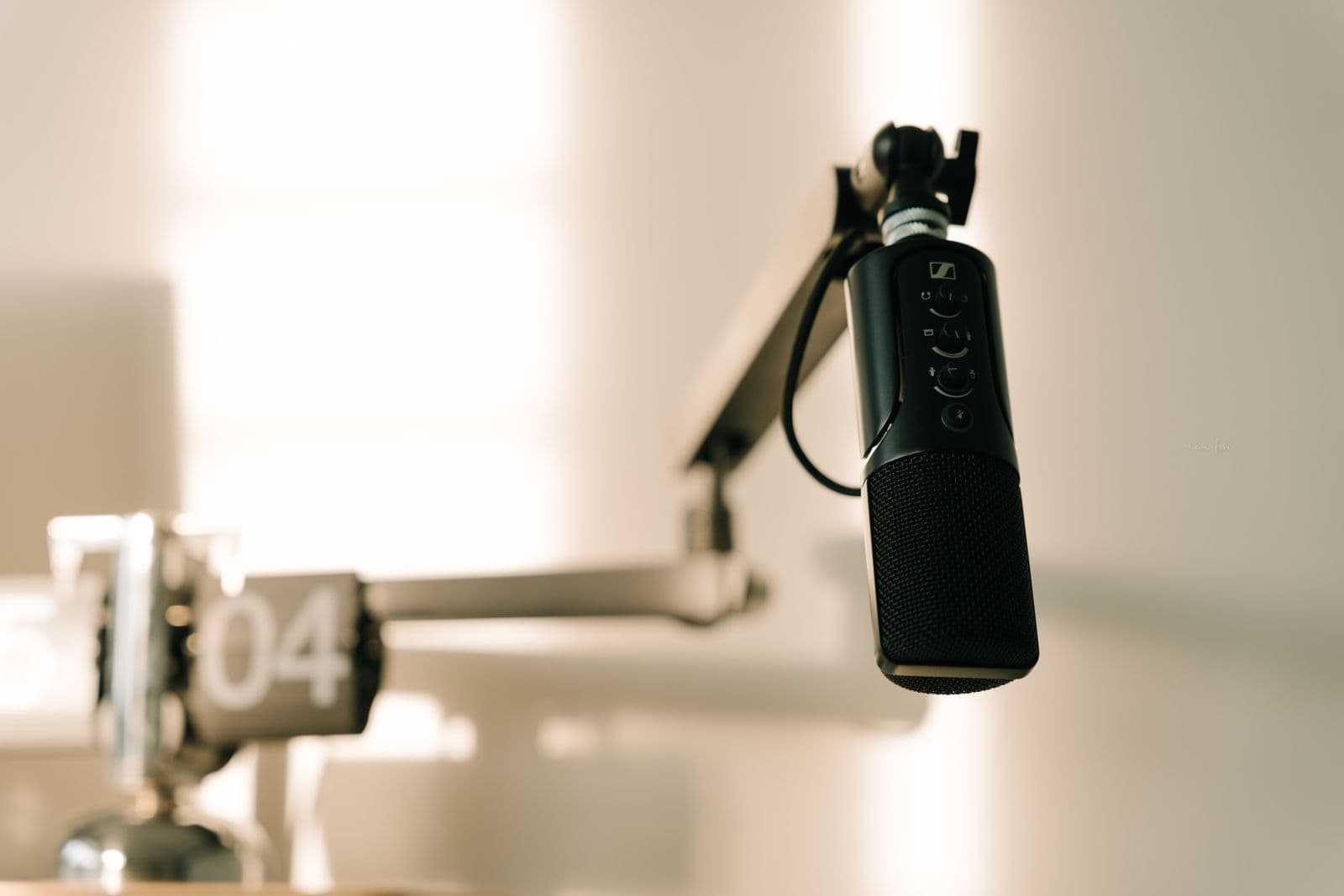 Studio microphone on a boom arm in warm light