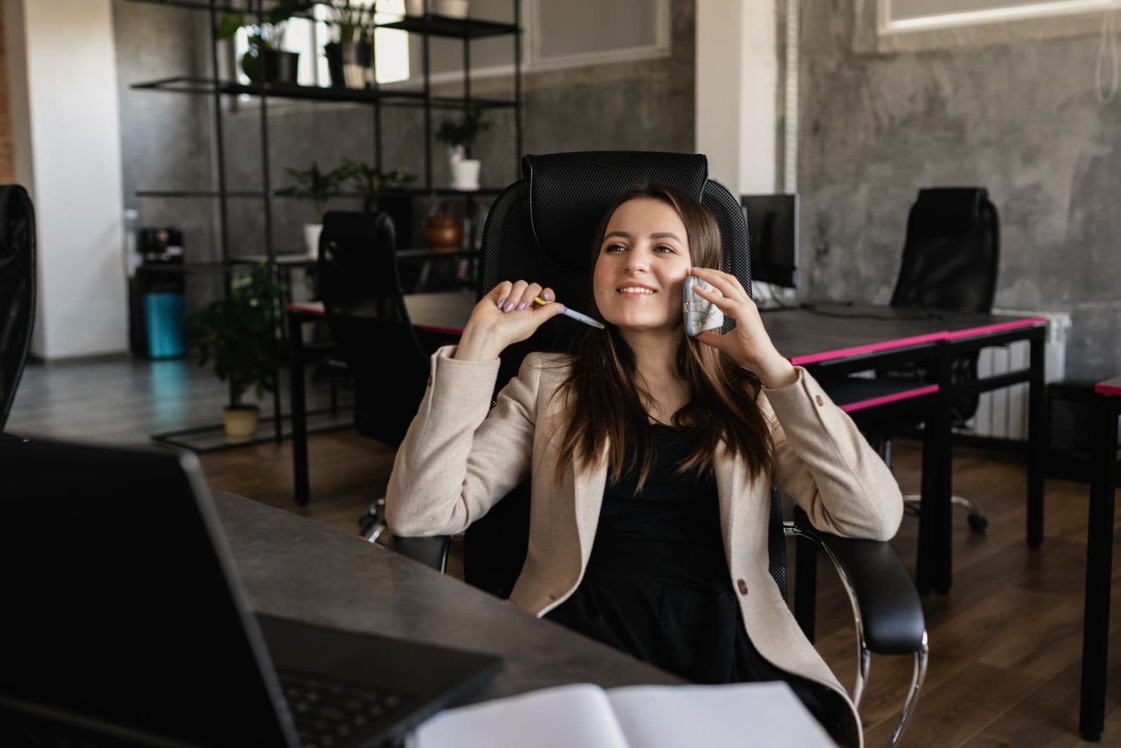 Caller relaxing at a desk while talking on the phone