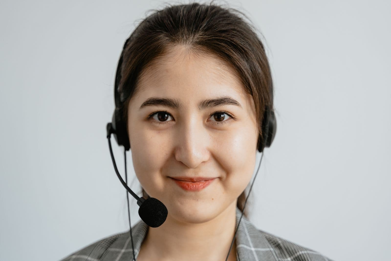 Customer service representative smiling while wearing a headset
