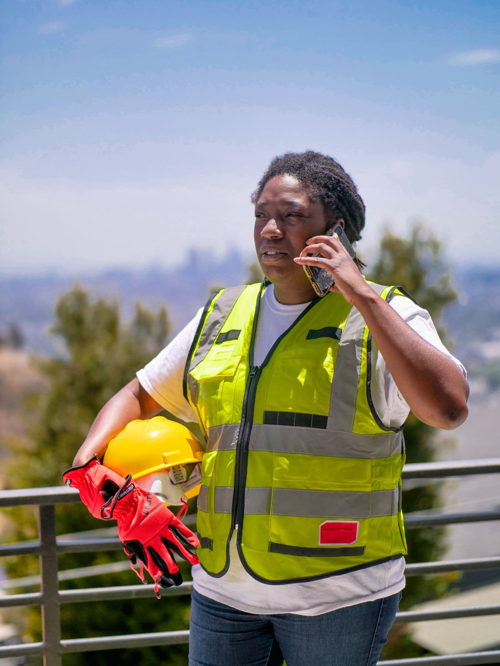 Construction worker in hi-vis taking a call on site